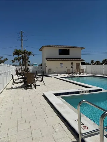 Community pool featuring a patio, a fenced backyard, and outdoor dining area