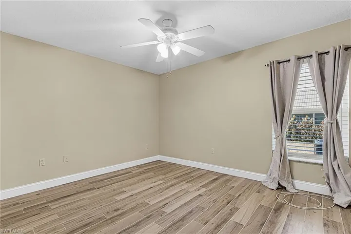 Empty room featuring light wood-type flooring and ceiling fan