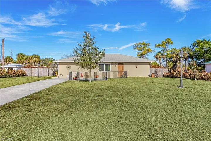 Single story home featuring stucco siding and a metal roof
