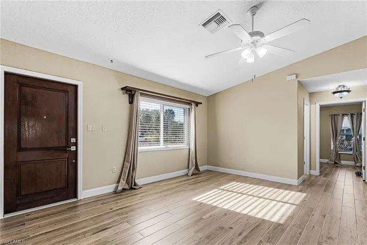Entrance foyer featuring a ceiling fan and light wood-style floors