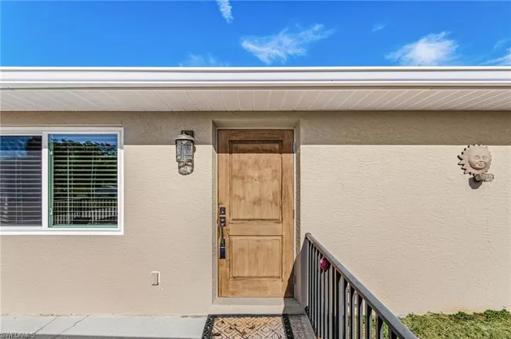View of exterior entry featuring stucco siding