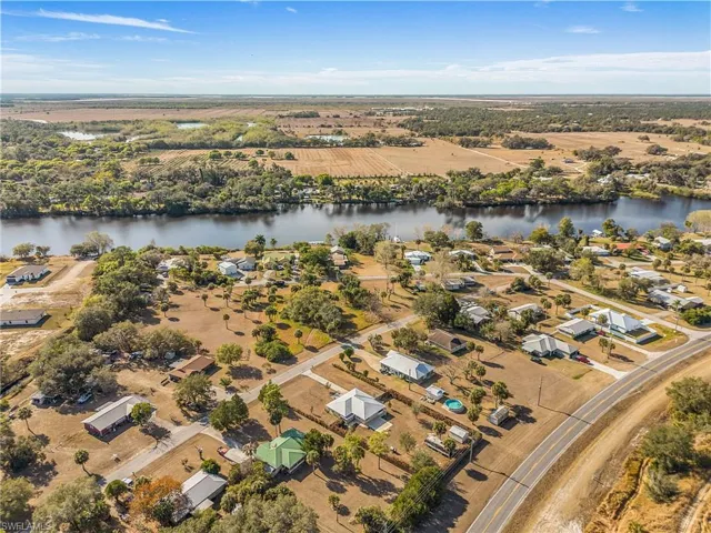 Aerial overview of property's location featuring rural landscape and nearby suburban area