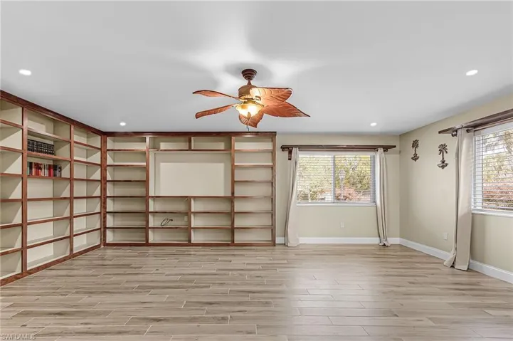 Unfurnished living room with wood tiled floors, recessed lighting, and ceiling fan