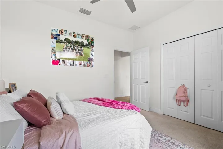 Bedroom featuring ceiling fan, a closet, and carpet floors