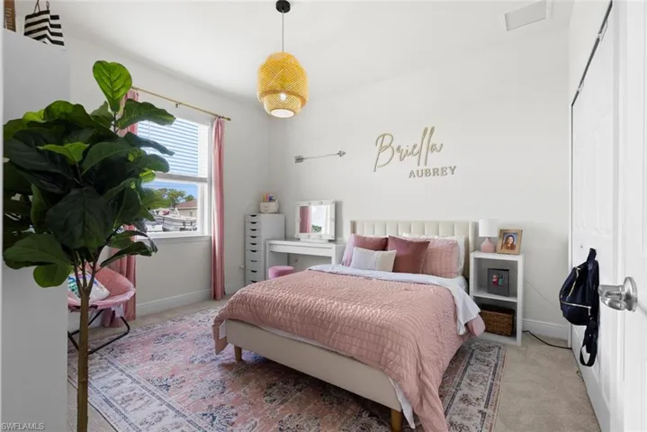 Bedroom featuring light colored carpet