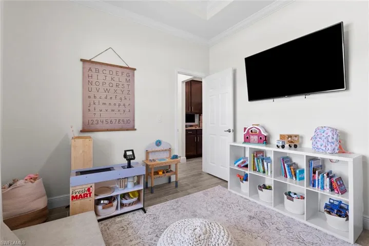 Rec room featuring light hardwood / wood-style flooring and ornamental molding