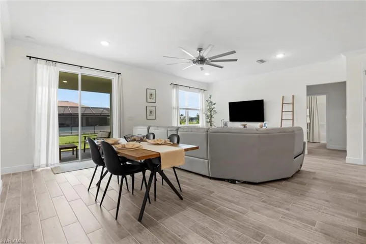 Dining area featuring ceiling fan, light hardwood / wood-style floors, and crown molding