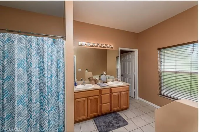 Bathroom with vanity and tile patterned floors
