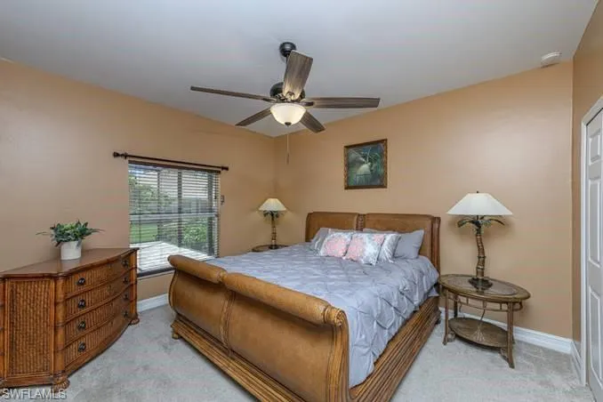 Bedroom featuring ceiling fan and light carpet