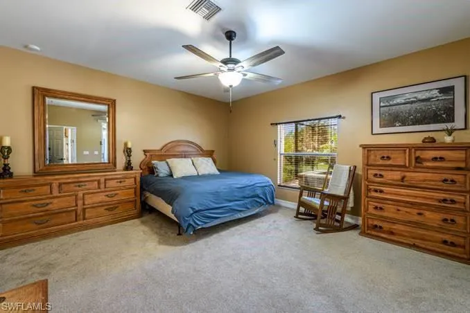 Carpeted bedroom with ceiling fan