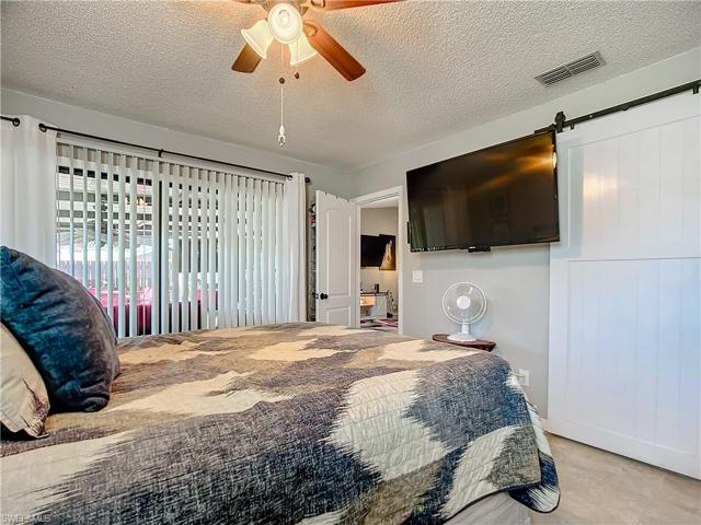 One of the bedrooms on the kitchen end of the villa with a bathroom behind the barn door