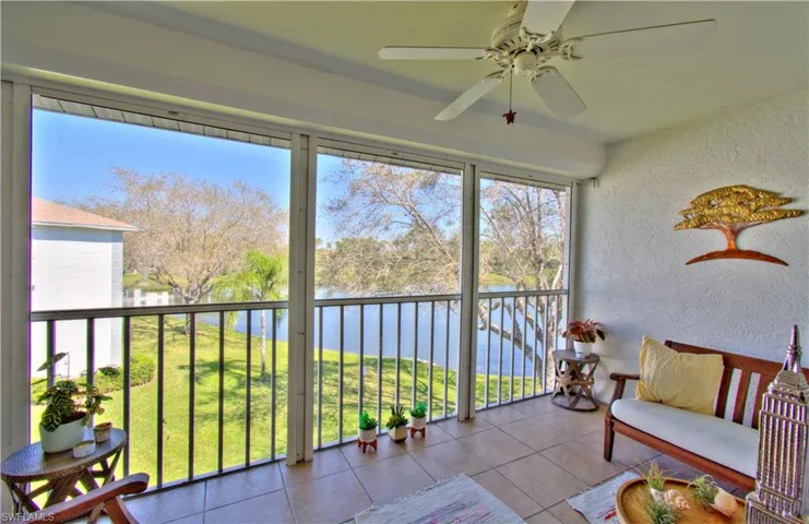 Sunroom / solarium with a water view
