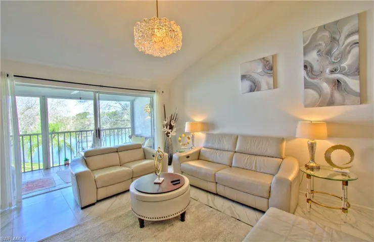 Living room with lofted ceiling and a chandelier