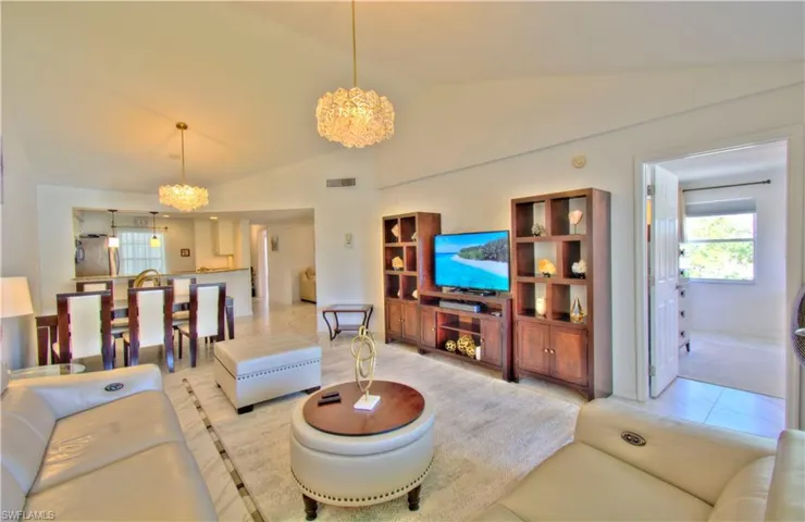Living area with a chandelier and lofted ceiling