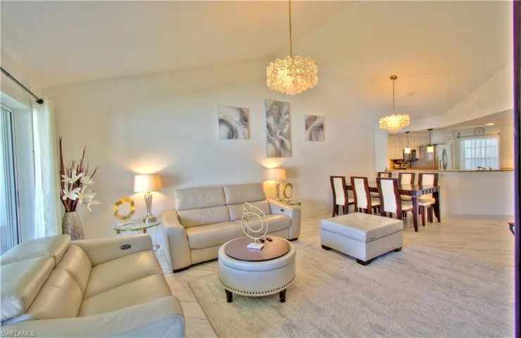 Living area with a chandelier and vaulted ceiling