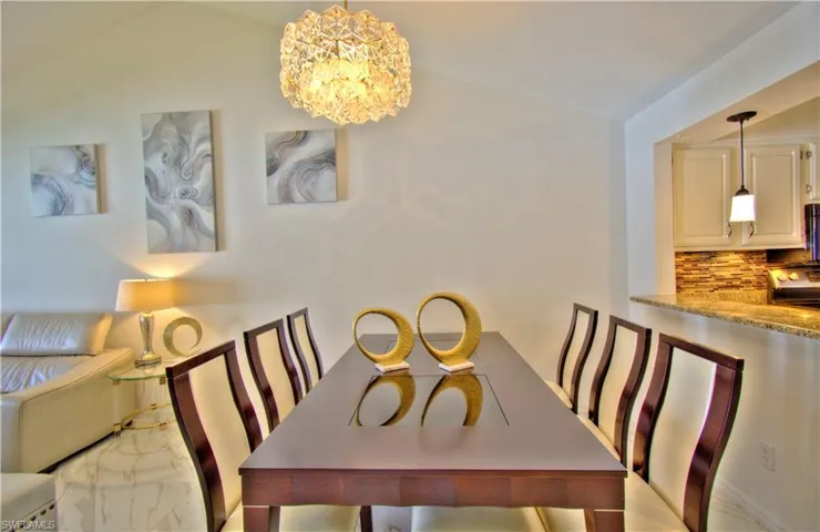Dining room with a chandelier and lofted ceiling