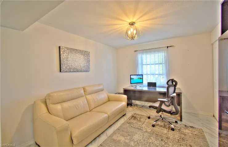 Office area with baseboards and suspended lighting