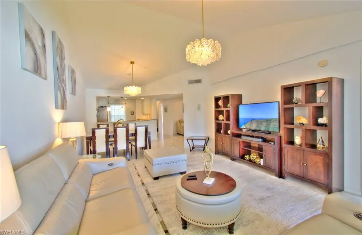Living area with a chandelier and lofted ceiling