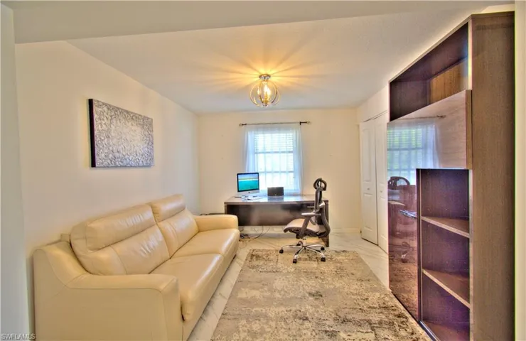 Home office with suspended lighting and baseboards