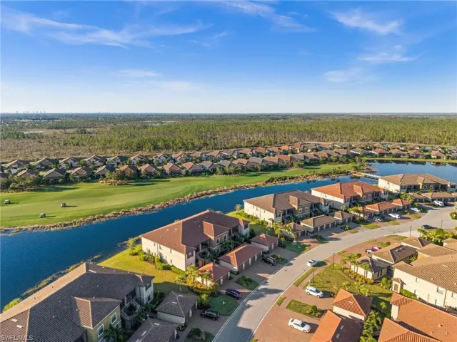 Birds eye view of property with a water view