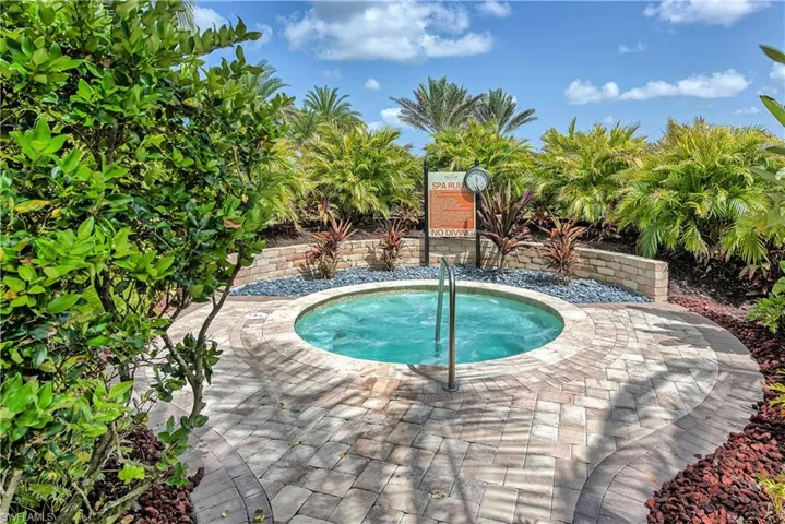 View of swimming pool featuring an in ground hot tub