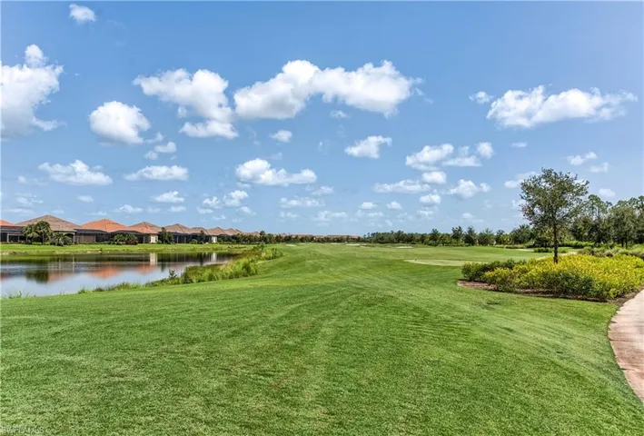 View of home's community featuring a yard and a water view