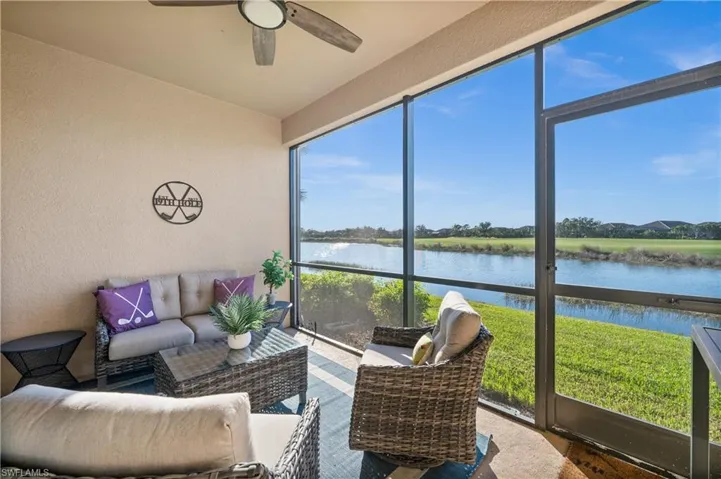 Sunroom / solarium featuring a water view, ceiling fan, and a healthy amount of sunlight