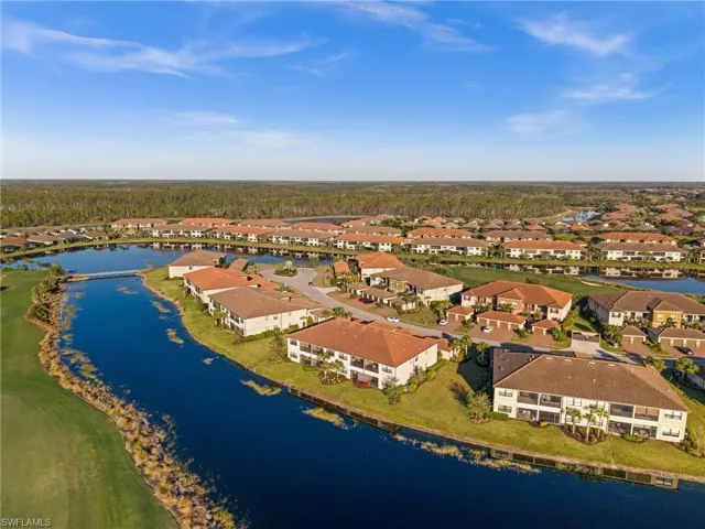 Birds eye view of property with a water view