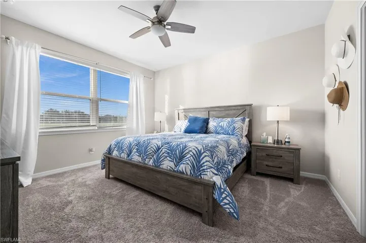 Carpeted bedroom with ceiling fan
