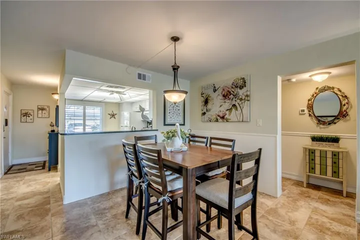 Dining area is next to hallway to bedrooms/bathrooms.