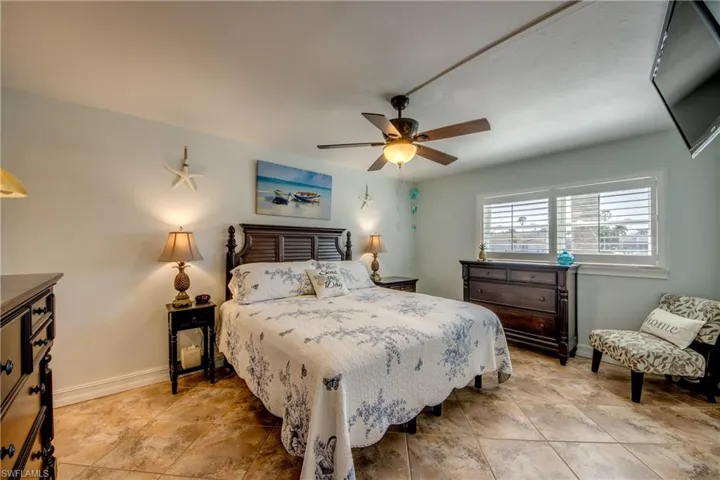 Primary bedroom windows look out to the canal. Plantation shutters cover all of the windows.