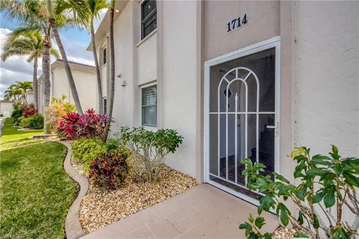 Only 4 units use this entrance. A1 is first floor on the left. Tropical plants and trees are throughout the property.