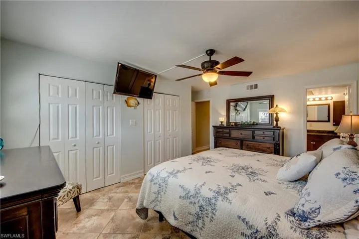 Spacious primary bedroom has a closet that runs the length of the wall.