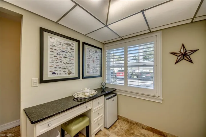 Built-in desk in kitchen and beverage refrigerator.