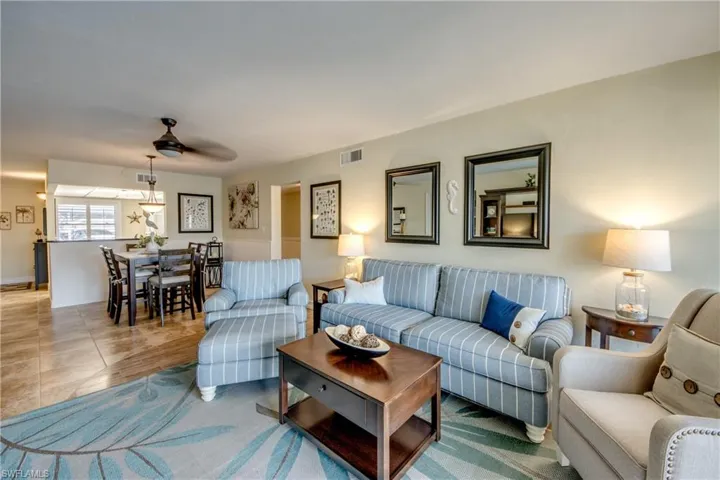 Living room is open to dining room. Tile flooring throughout unit. Newer living room furniture.