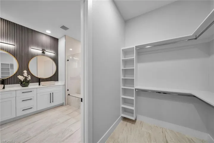 Walk in closet with visible vents and a sink
