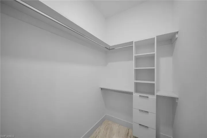 Spacious closet featuring light wood-type flooring