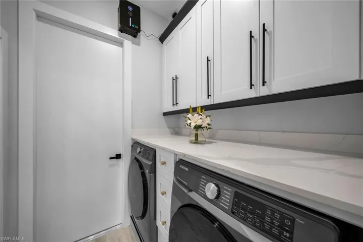 Laundry area with cabinet space and independent washer and dryer