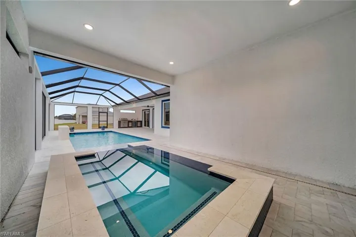 Pool with a patio area, a lanai, and an in ground hot tub