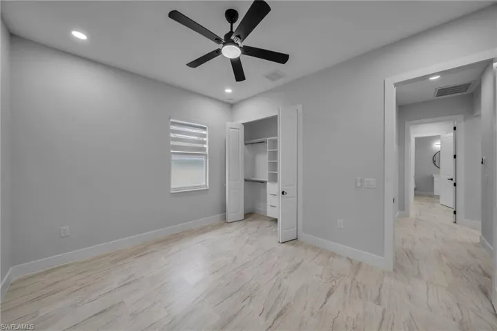 Unfurnished bedroom featuring ceiling fan, baseboards, visible vents, and recessed lighting