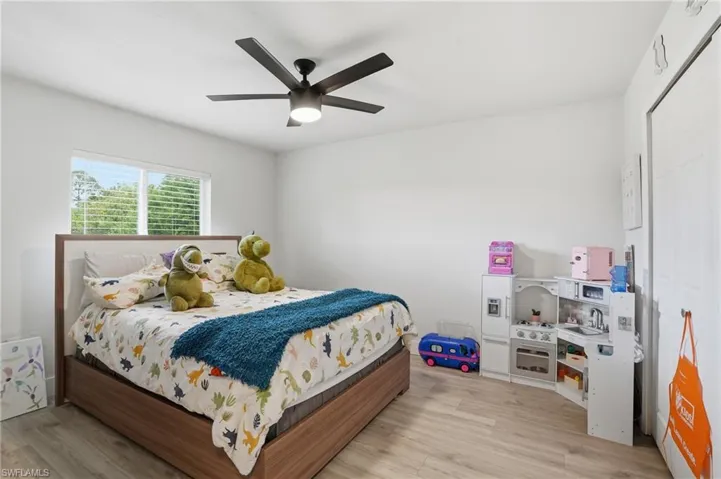 Bedroom with ceiling fan and light wood finished floors