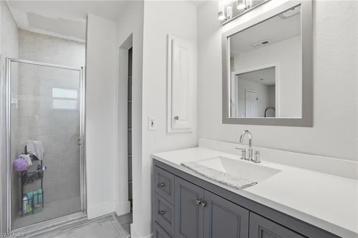 Bathroom with vanity and a shower stall