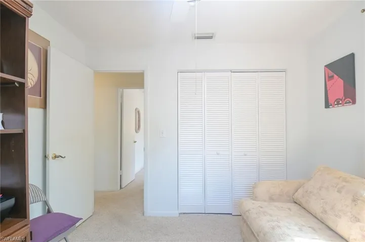 Sitting room/ bedroom  featuring light colored carpet