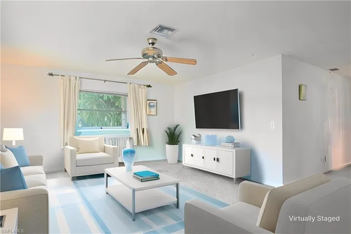 Virtually Staged: Living room featuring ceiling fan