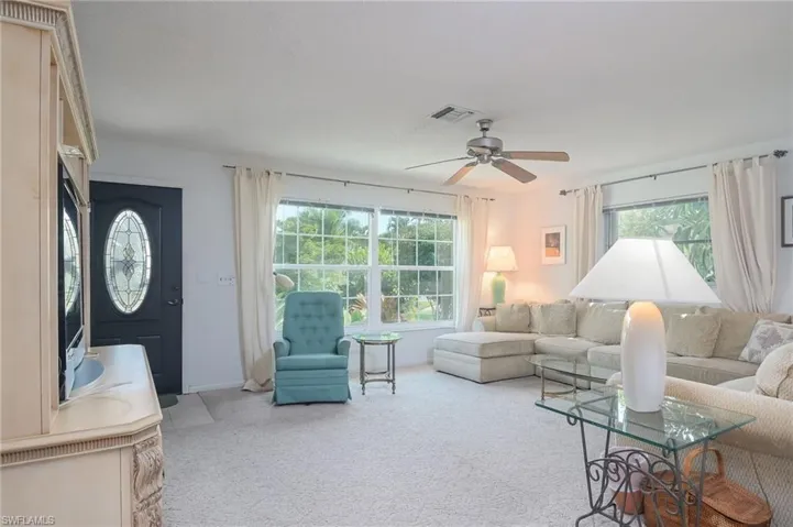 Living room with ceiling fan and carpet floors