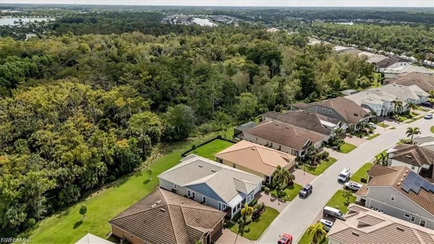 Aerial view of residential area featuring a heavily wooded area