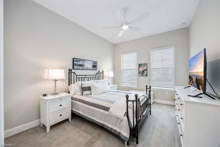 Bedroom with light colored carpet and ceiling fan
