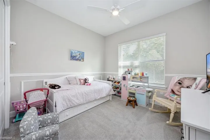 Carpeted bedroom with ceiling fan