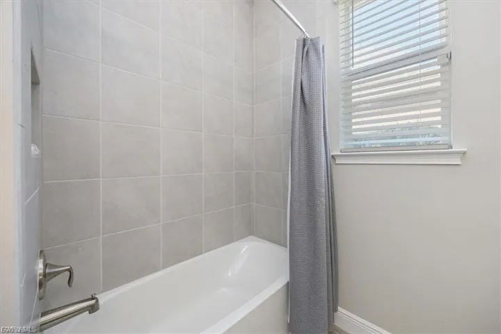 Full bath with shower / bath combination with curtain