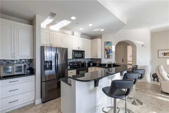 Extended kitchen opens to living room and lanai/waterfront